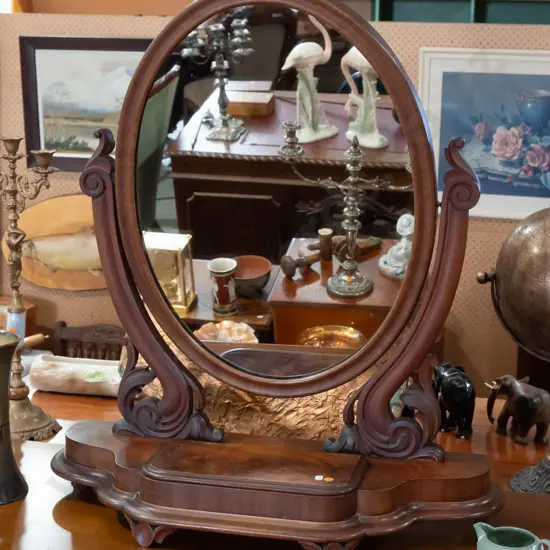 Victorian mahogany tabletop cheval mirror, oval mirror with foliate carved supports, lift-up lid, shaped front on