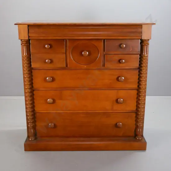 reproduction colonial style beech 8-drawer chest w/ shaped top drawer, wooden knobs on others, turned pilasters, on