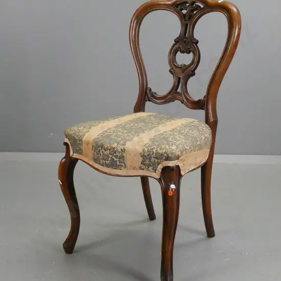 Victorian walnut side chair with foliate carved and pierced back on sweeping carved cab legs, with faded floral