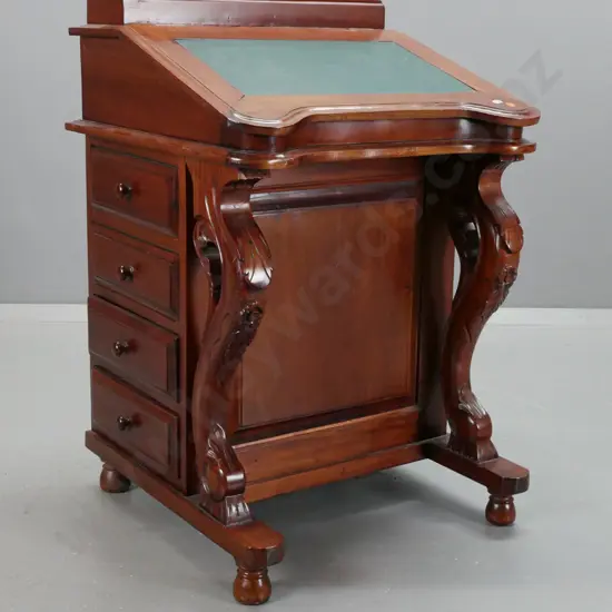 reproduction mahogany Victorian-style Davenport desk with inlaid leather writing surface, 8 interior drawers, carved