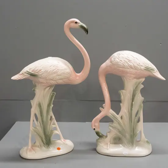pair of pink flamingo figures, no maker's marks, one with head down has manufacturing crack to leg and 2 small chips.