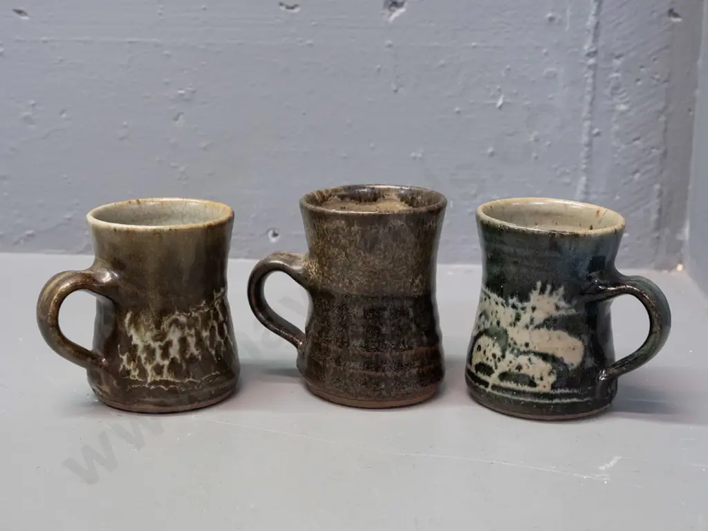 3 Mirek Smíšek New Zealand studio pottery mugs with sunflower maker's mark below handle - 3 colours, one has minor chip Image 1++