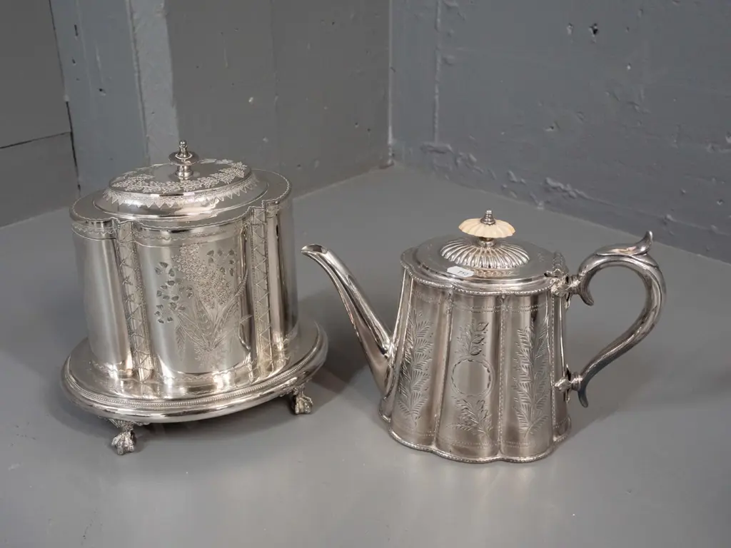 ornately etched plated ware - teapot with bakelite or plastic knob, scalloped body and a hinged lid canister with base Image 1++