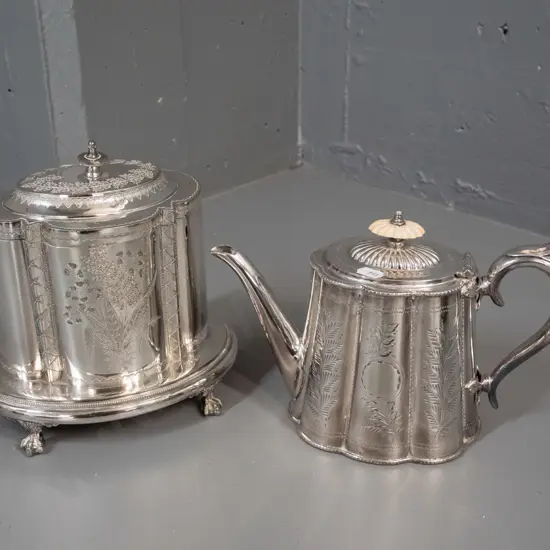ornately etched plated ware - teapot with bakelite or plastic knob, scalloped body and a hinged lid canister with base