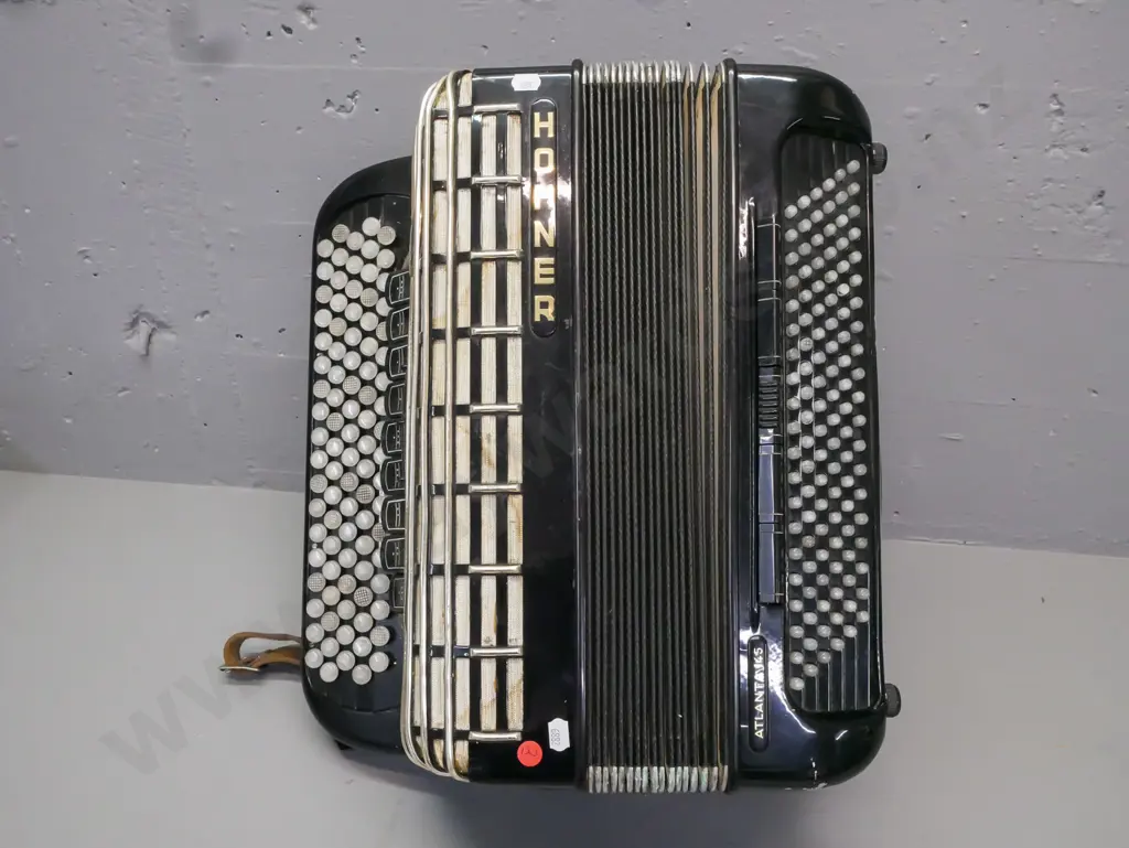 cased Hohner Atlanta 145 button accordion. Strap is worn & cracked, overall wear, discolouration to grille fabric, Image 1++