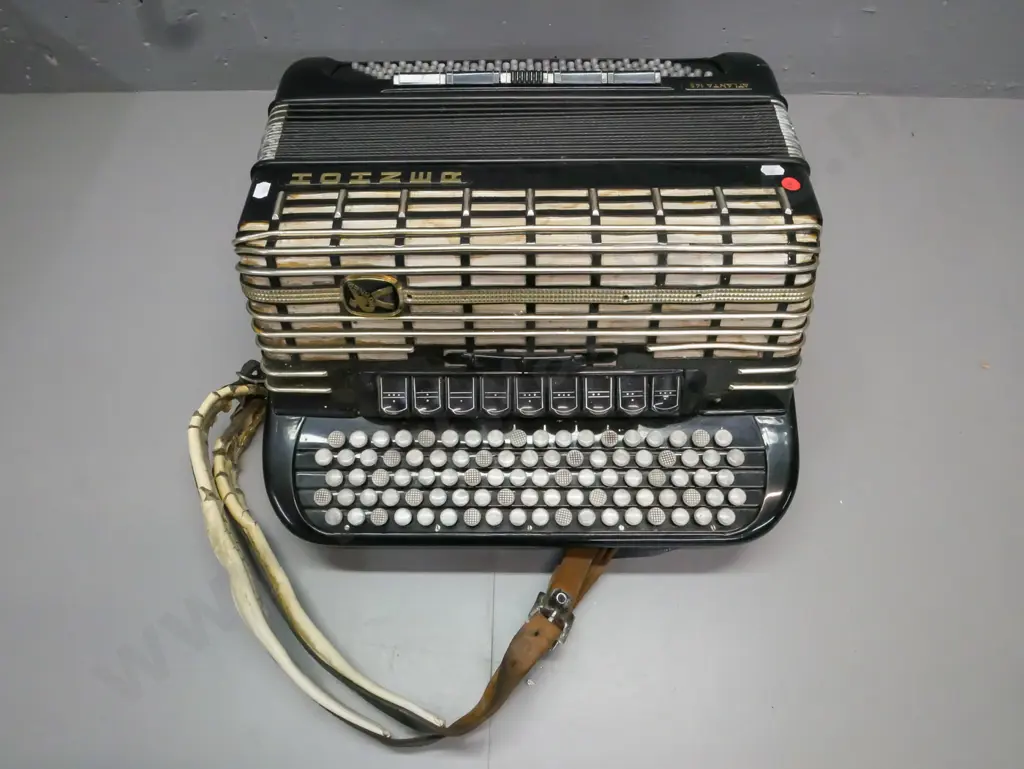 cased Hohner Atlanta 145 button accordion. Strap is worn & cracked, overall wear, discolouration to grille fabric, Image 1++