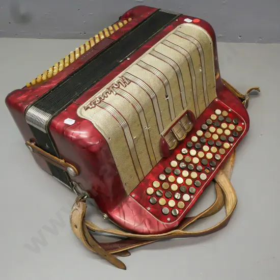cased Hohner Maestro II button accordion, has one missing button. Wear to leather strap, overall wear and some corrosion