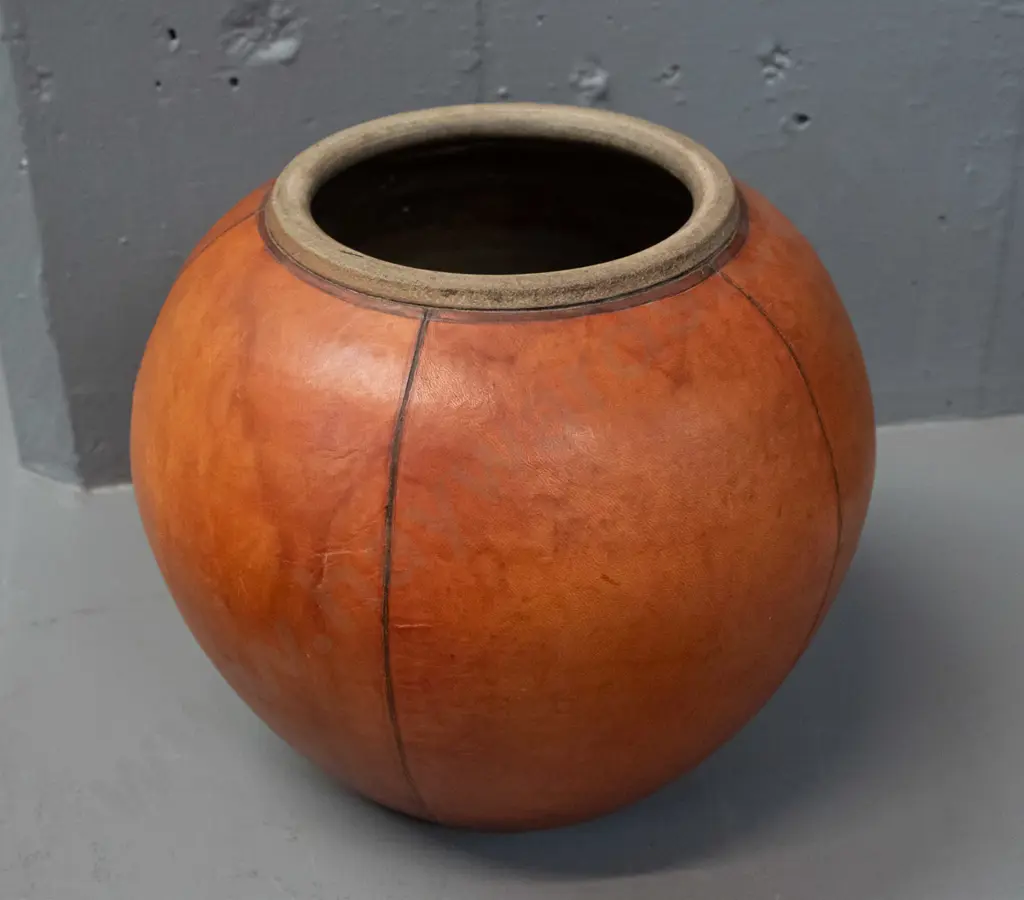 lidded studio pottery pot with leather covering - has break through pottery layer of lid H-200 D-200 - label for B.N.R. Image 1++