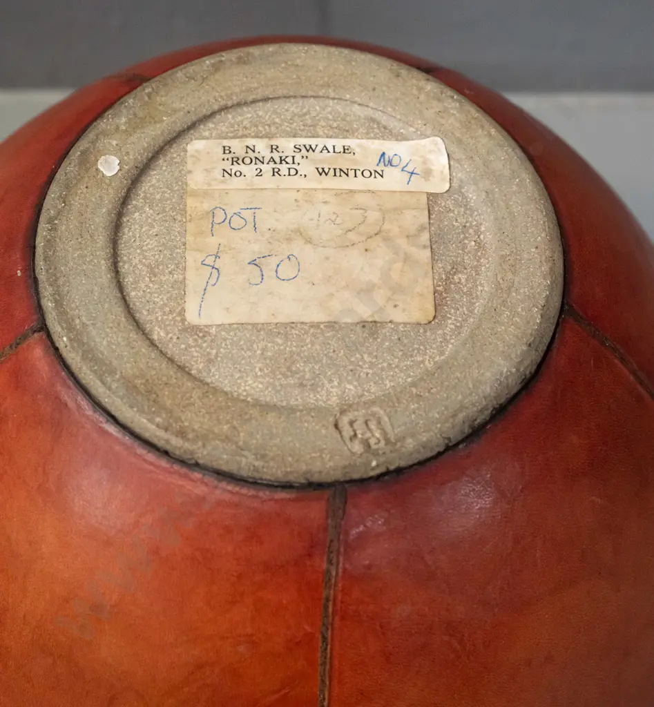 lidded studio pottery pot with leather covering - has break through pottery layer of lid H-200 D-200 - label for B.N.R. Image 1++
