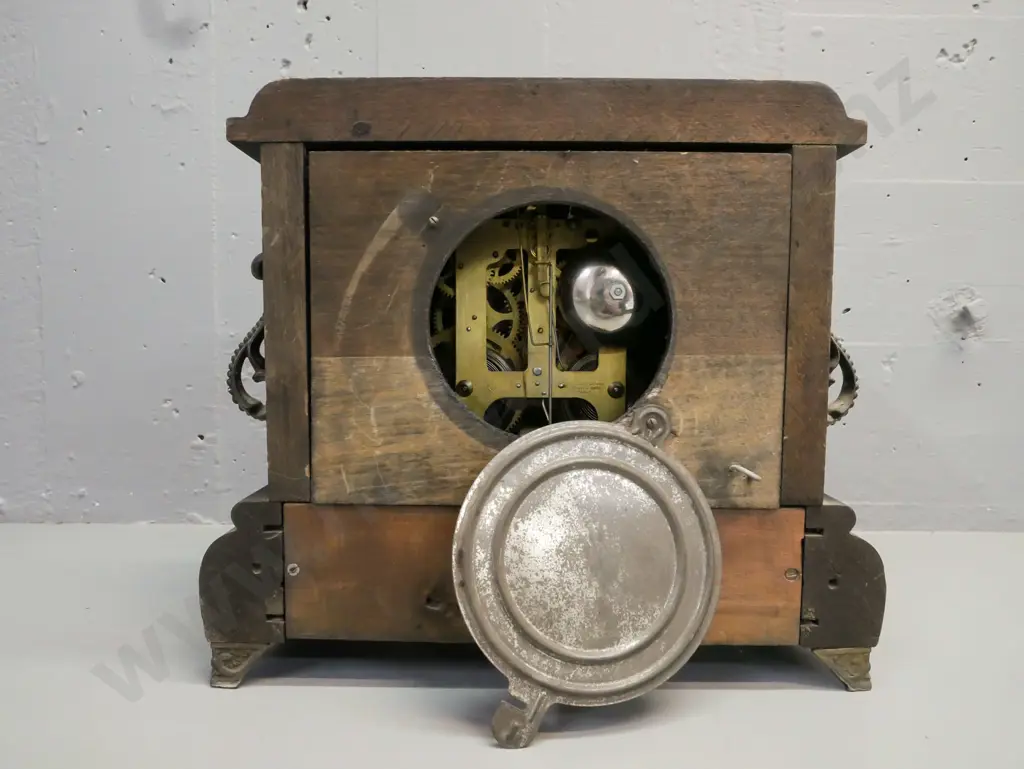ebonised wooden mantel clock w/ marbled corners, applied scrolling cast handles, paw feet, gilded face. Gilbert Clock Co Image 1++