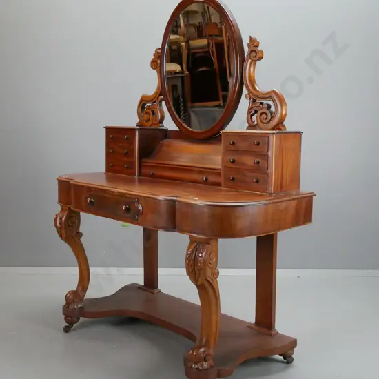 Victorian mahogany dressing table with oval mirror on foliate carved supports - break front top on shaped carved