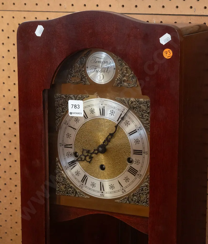 small mahogany long-case chiming clock on cabriolet-foot base, with arched glazed door, wood & brass pendulum, silver Image 1++