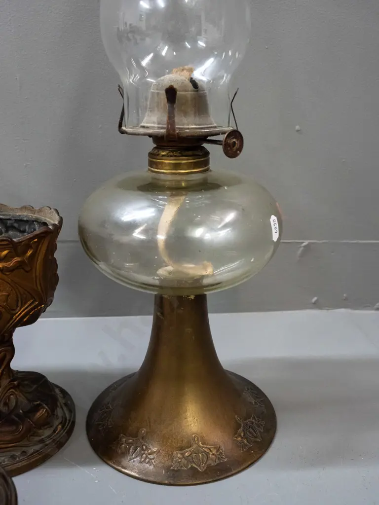 3 vintage kerosene lamps - brass base with nouveau style repeating pattern, clear glass tank & chimney, knob marked Image 1++