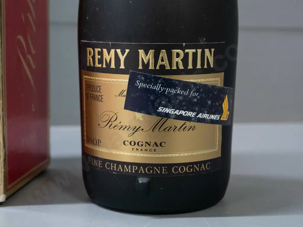 bottle of Remy Martin cognac Fine Champagne VSOP, with "Specially Packed for Singapore Airlines" sticker on bottle. Wear Image 1++