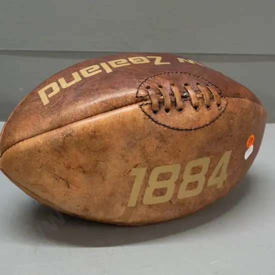 leather rugby ball with gilt "New Zealand" and "1884" markings - some fading to one side L-340