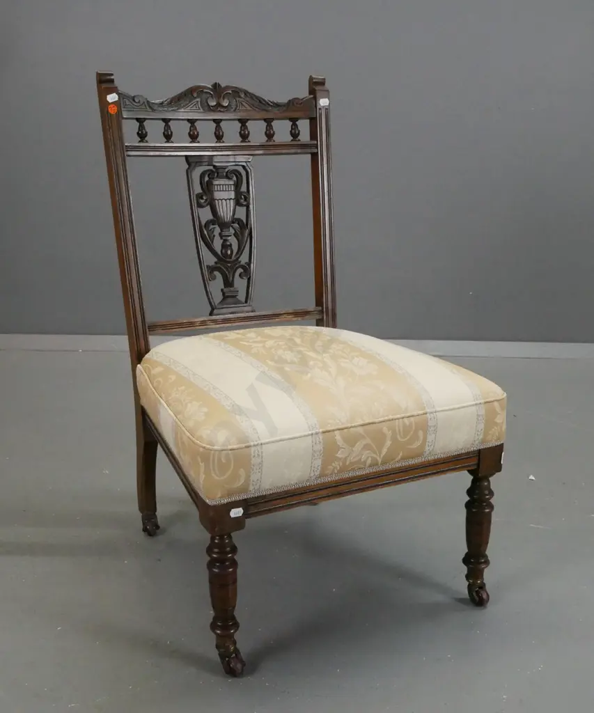 Edwardian beech and walnut bedroom chair with carved back splat and top rail, on porcelain casters, striped upholstered Image 1++