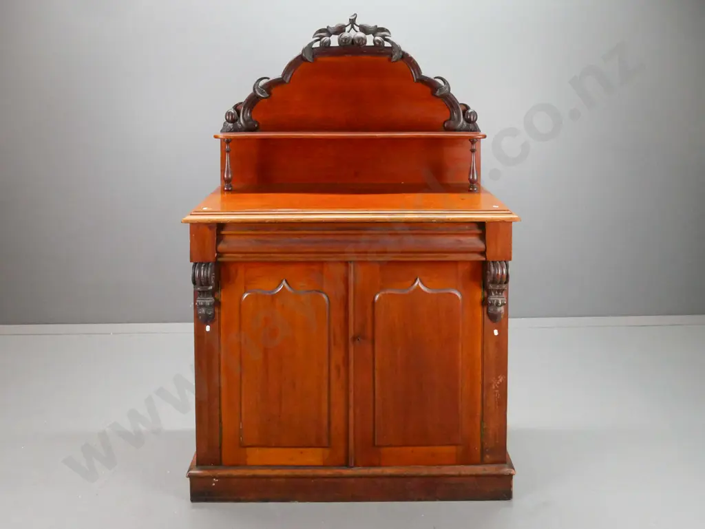 NZ colonial cedar carved-back chiffonier with shaped top shelve, drawer over 2 shield-panelled doors, kauri interior. Image 1++