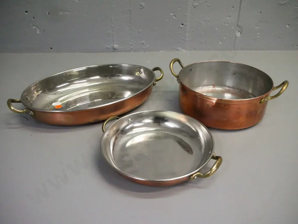 3x double-handled copper pans w/ white metal interior & brass handles. One is well-used: corrosion, scratching etc. Image 1++