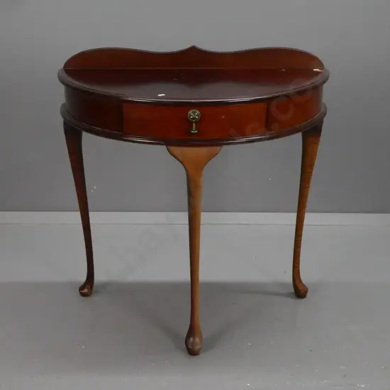 Demi-lune hall or side-table in mahogany & beech w/ shaped upstand, central drawer w/ drop handle, on shaped cabriole