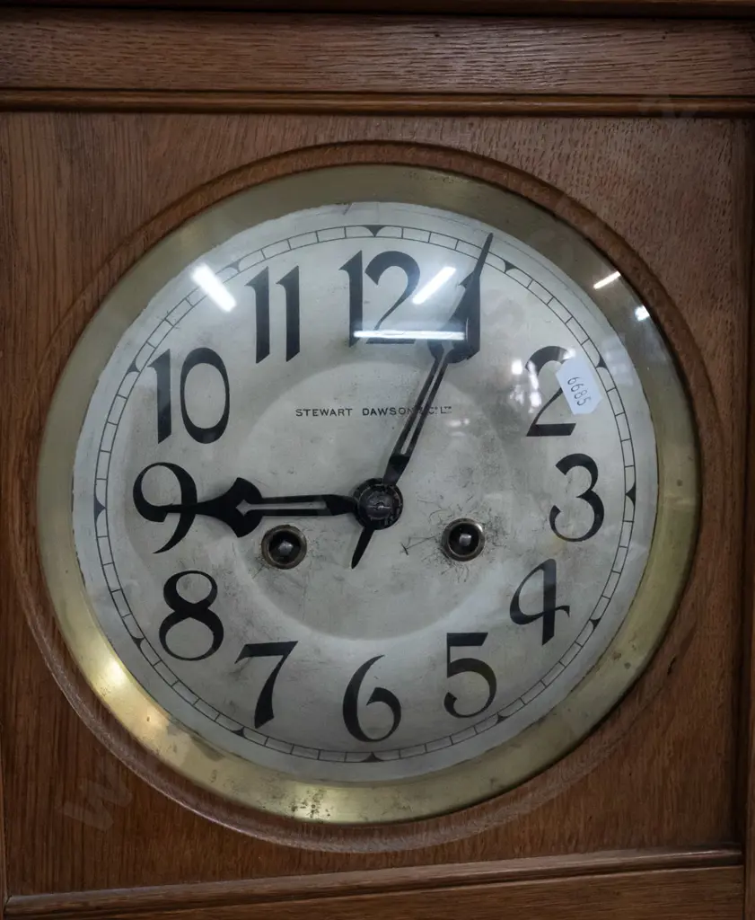 vintage oak-cased chiming wall clock w/ silvered dial marked Stewart Dawson & Co, brass bezel. Bevelled leadlight door, Image 1++