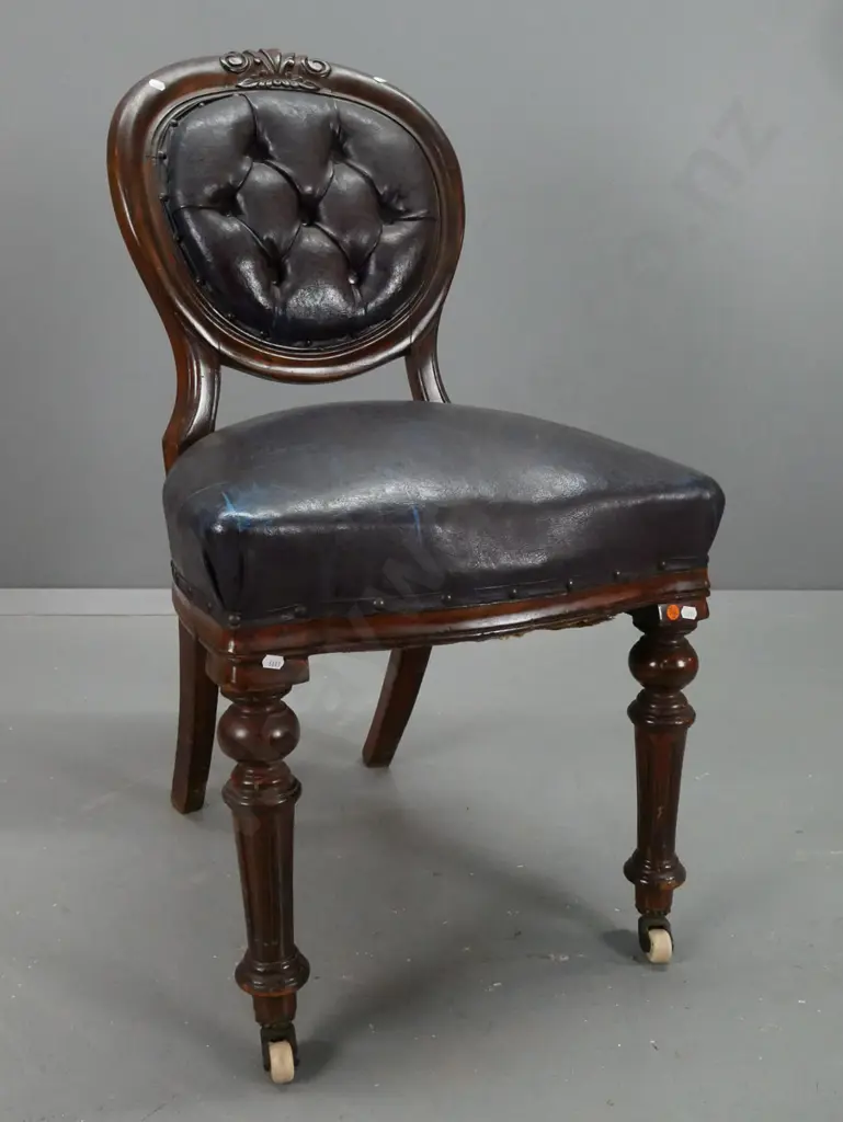 Victorian mahogany medallion-back side chair with carved back, turned fluted legs on porcelain casters, deep-button Image 1++