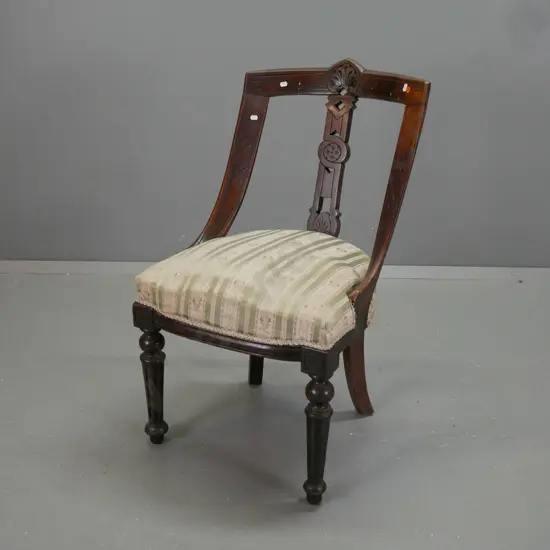 Victorian mahogany saddle-back chair with pierced and carved back splat & top rail, turned & fluted front legs, green &