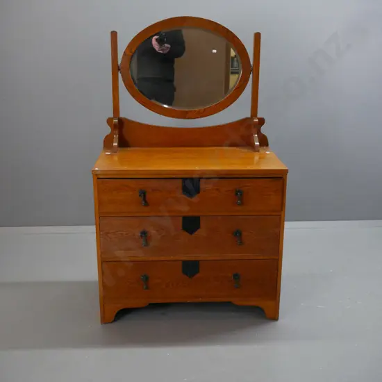 oak Art Deco-style dresser w/ oval bevel-edged mirror above 3 long drawers w/ metal drop handles, fluted ebonised