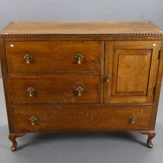 oak art deco buffet sideboard with shaped edge top, panelled sides, panelled door, 4 drawers with brass drop handles