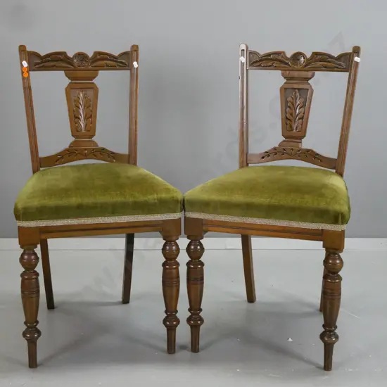 pair Edwardian beech side chairs with foliate carved crest rail and back splat, turned front legs, green velvet