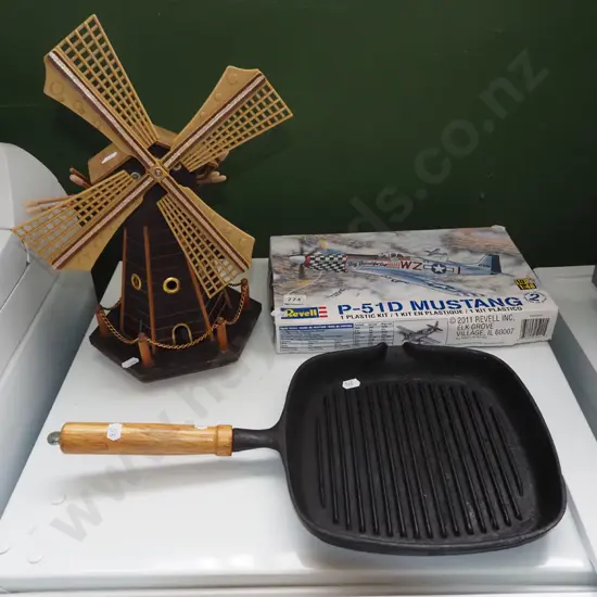 model windmill, cast iron skillet, yet to be assembled model of a Mustang plane