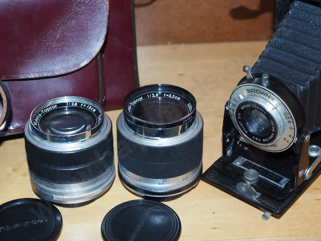Kodak brownie folding camera, 2 Topcon bayonet mount lenses with cases, camera bag Image 1++