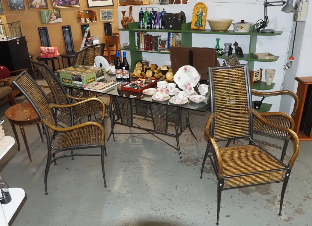 contemporary metal based glass top dining table with 6 matching bamboo and cane upholstered carver chairs H740 W1700 D10 Image 1++