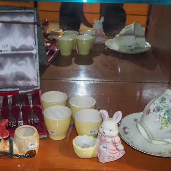 egg cups, cups, saucers, cake forks