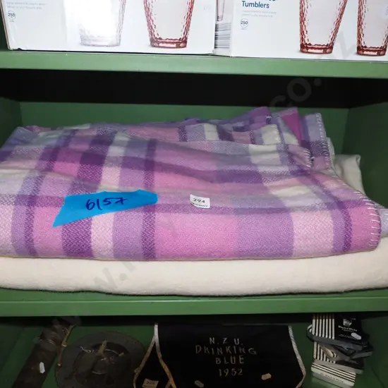 1x purple checked and 1x cream woollen blankets