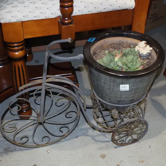 succulents in black planter on metal bike stand