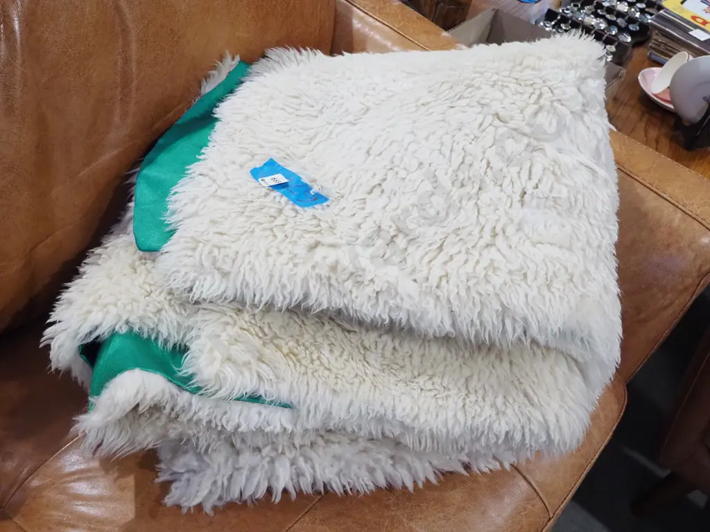 white sheepskin floor mat with green fabric backing L1800 Wapprox1400 Image 1++