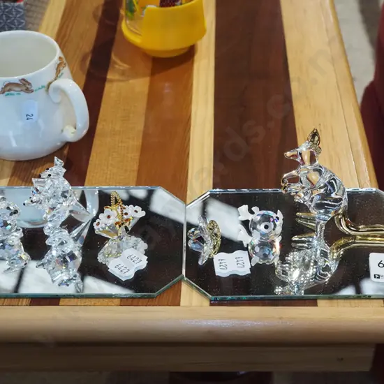 various cut crystal ornaments on mirrored base