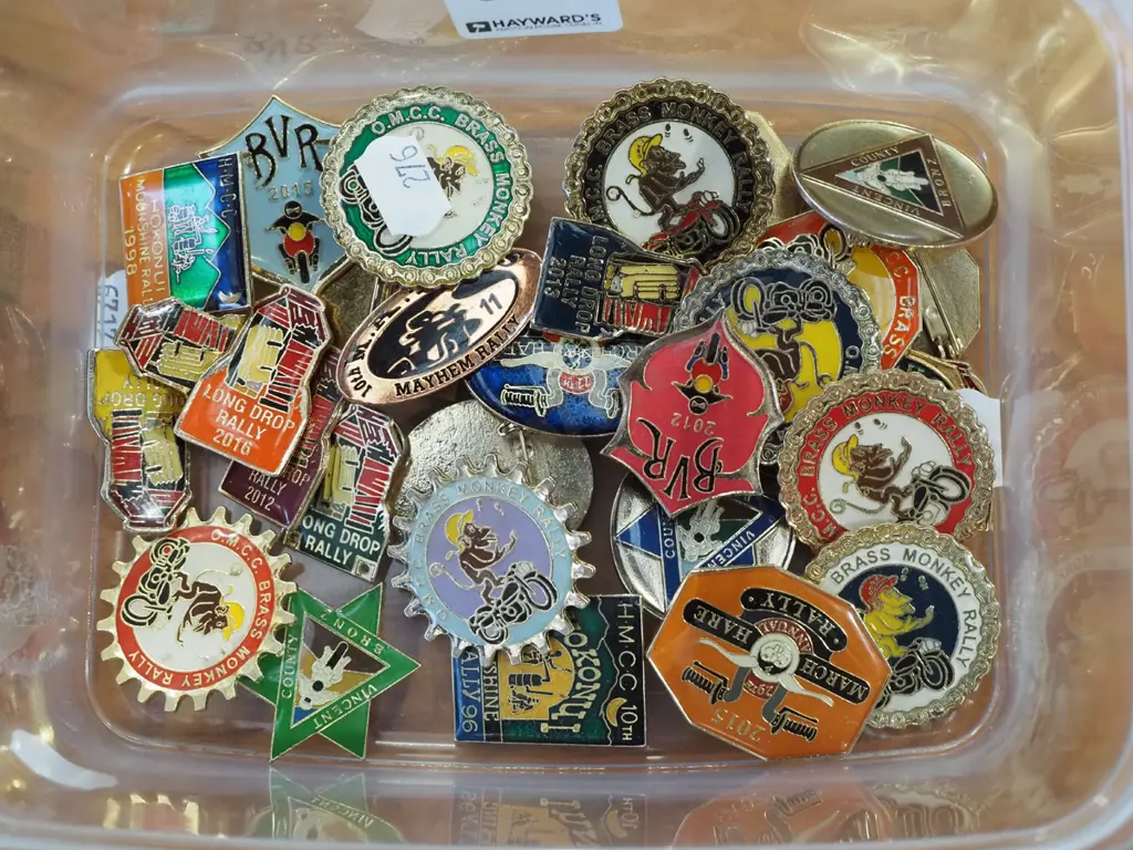 container of brass monkey and other rally badges Image 1++