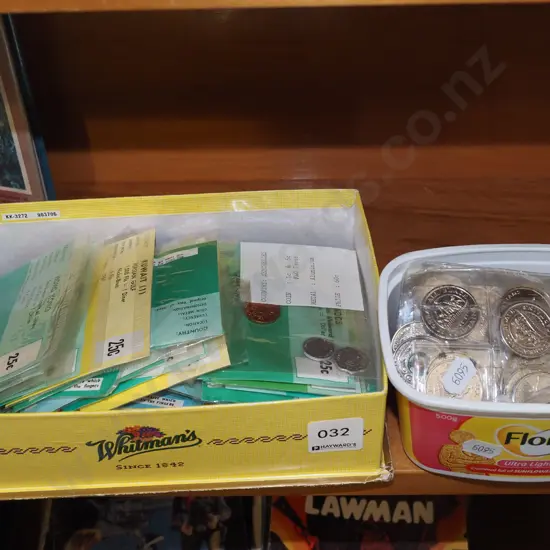 box of international coins, tub of All Blacks collector coins