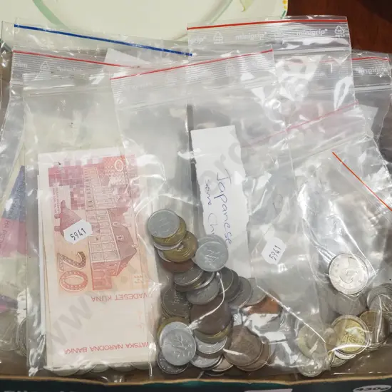 box of various banknotes and coins