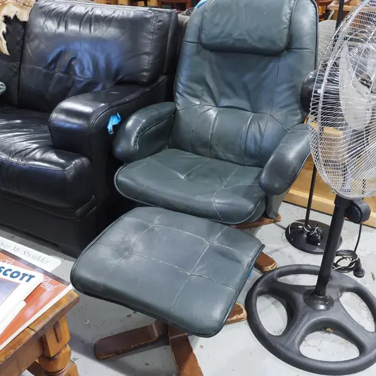 green vinyl upholstered swivel chair with matching footstool