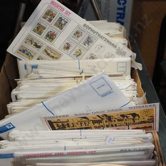 box of numerous stamp sets in envelopes