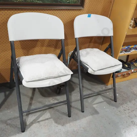 2x metal and plastic foldaway outdoor chairs with cushions