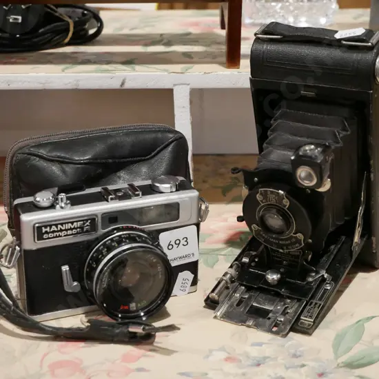 vintage Kodak folding camera and a Hanimex 35mm film camera