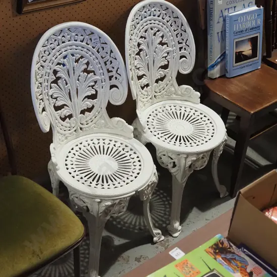 2x white painted cast alloy patio chairs