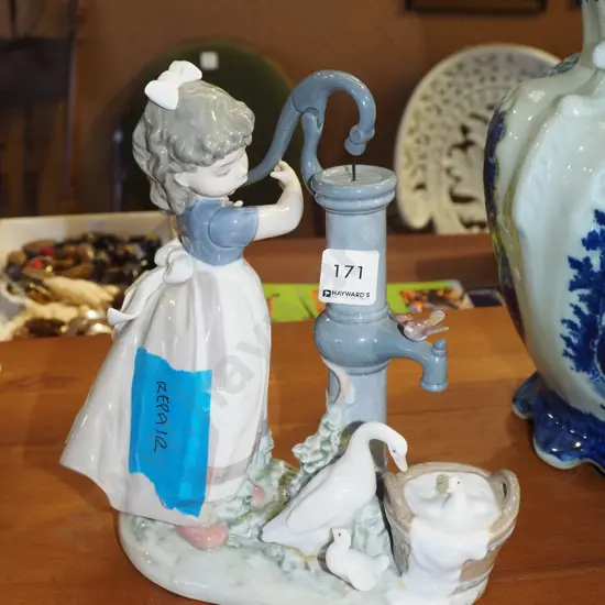Lladro figurine - girl at pump - has repair H250