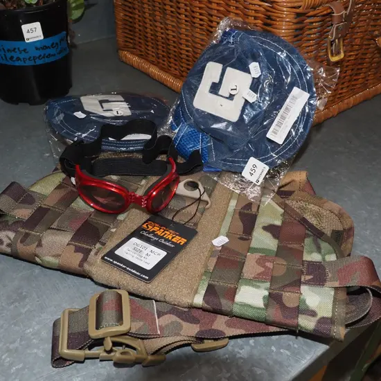 camoflauge dog jacket, dog caps, pair of goggles