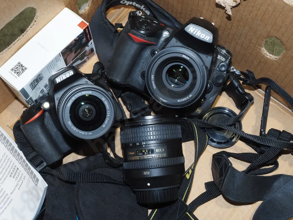 box; 2x Nikon digital SLR cameras, 3 lenses, flash, tripod etc. Image 1++