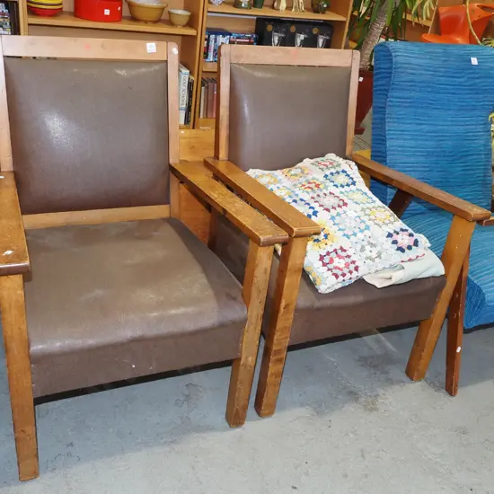 pair of rimu and brown vinyl armchairs