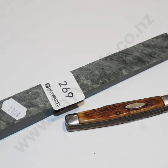 small pocket knife, cut green stone
